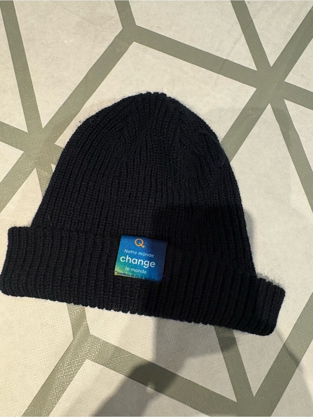 3/15$ Black Ribbed Beanie with Blue 'change' Patch